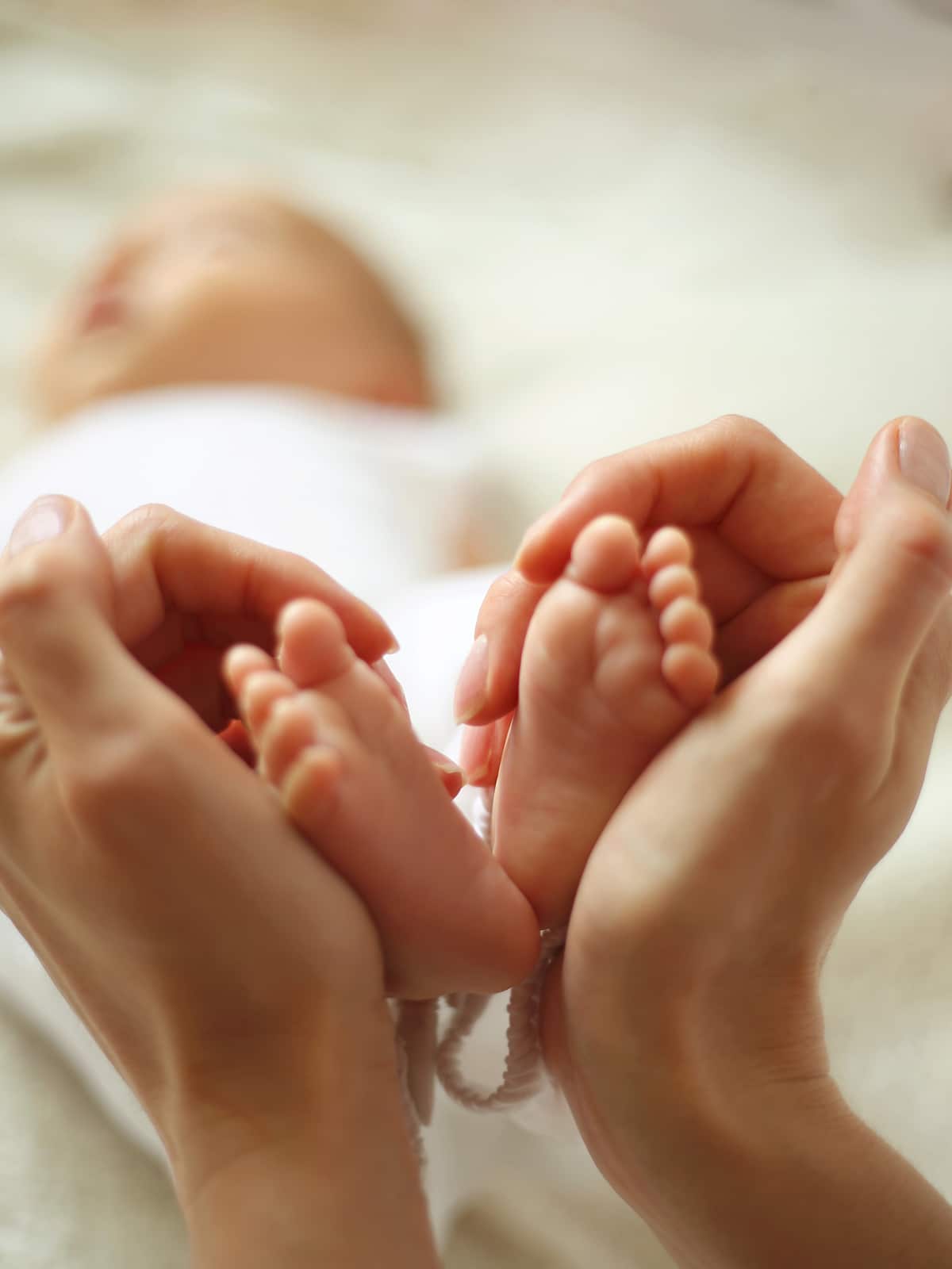 Baby feet in mother hands. Tiny Newborn Baby's feet on female He