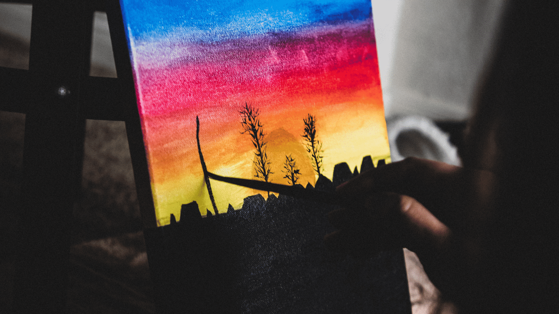 Pessoa pintando quadro de paisagem colorida