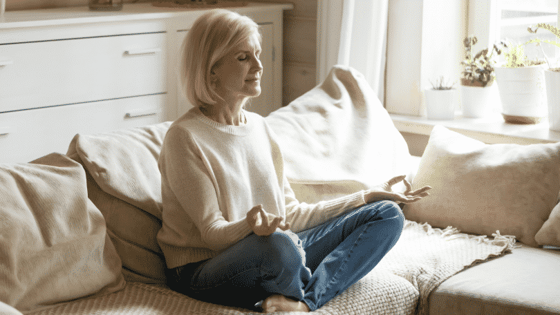 Mulher meditando em casa