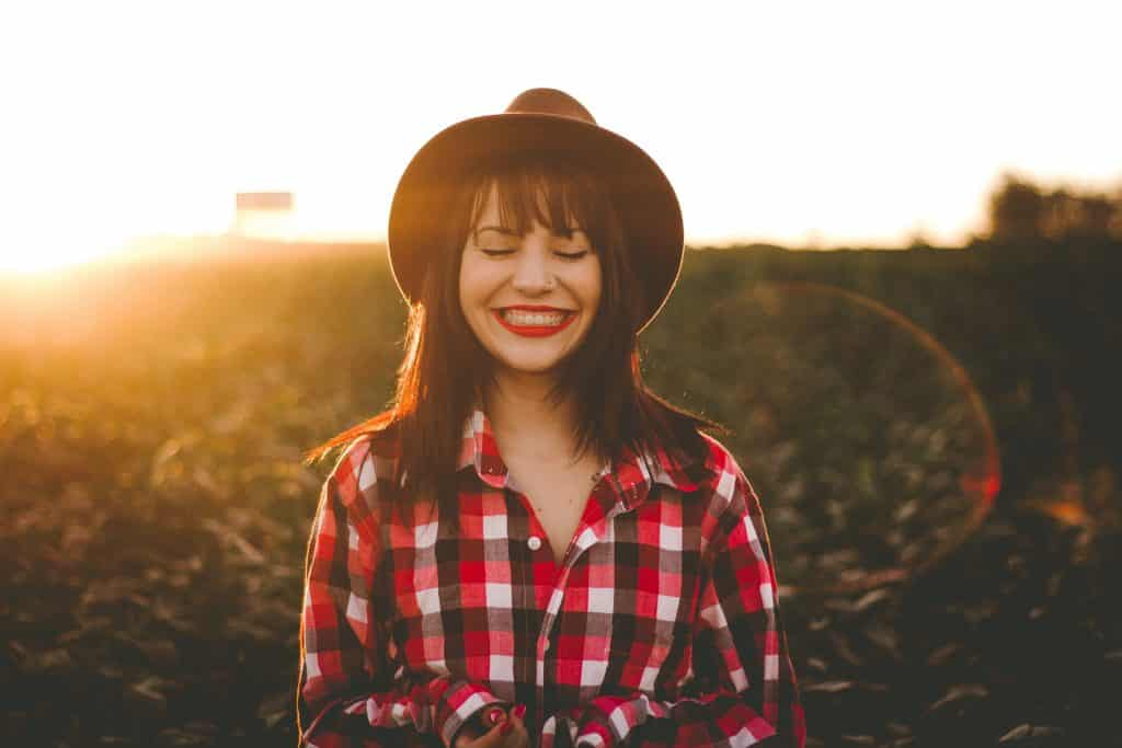 Mulher em um jardim de olhos fechados