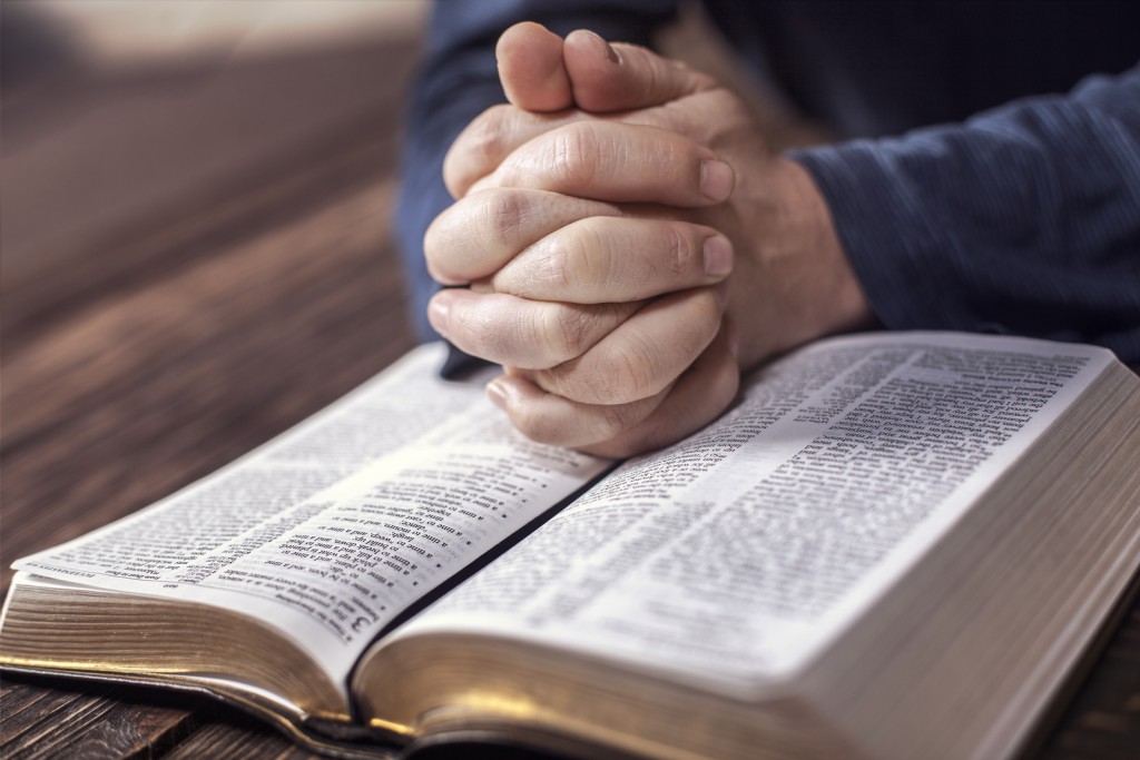 Man reading from the holy bible, close up