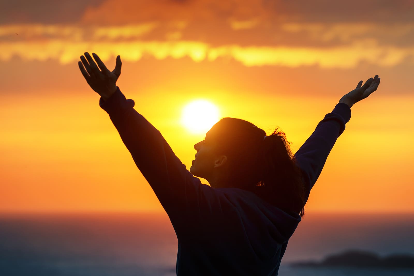 Woman Praising And Enjoying Golden Sunset