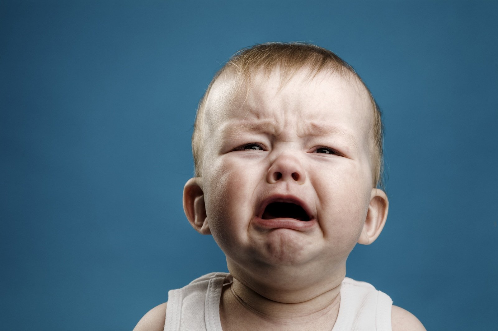 Photo of nine month baby crying isolated