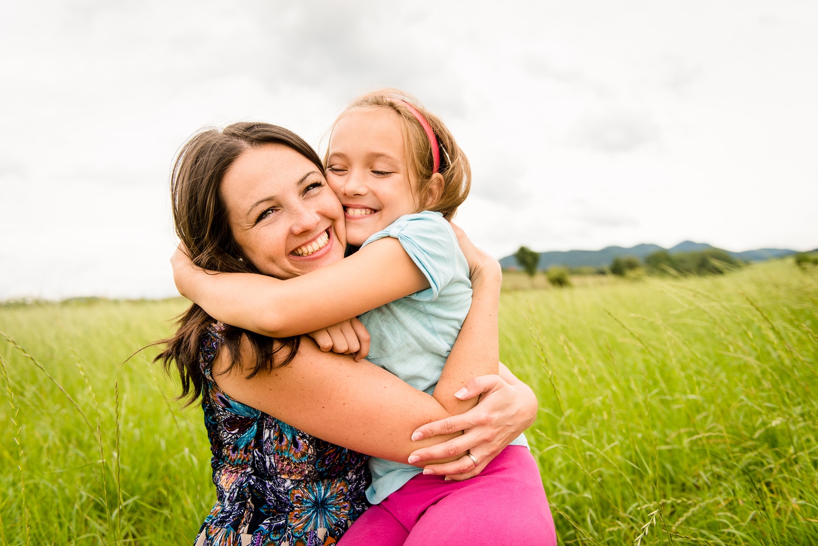 Mother and child are hugging and having fun outdoor in nature