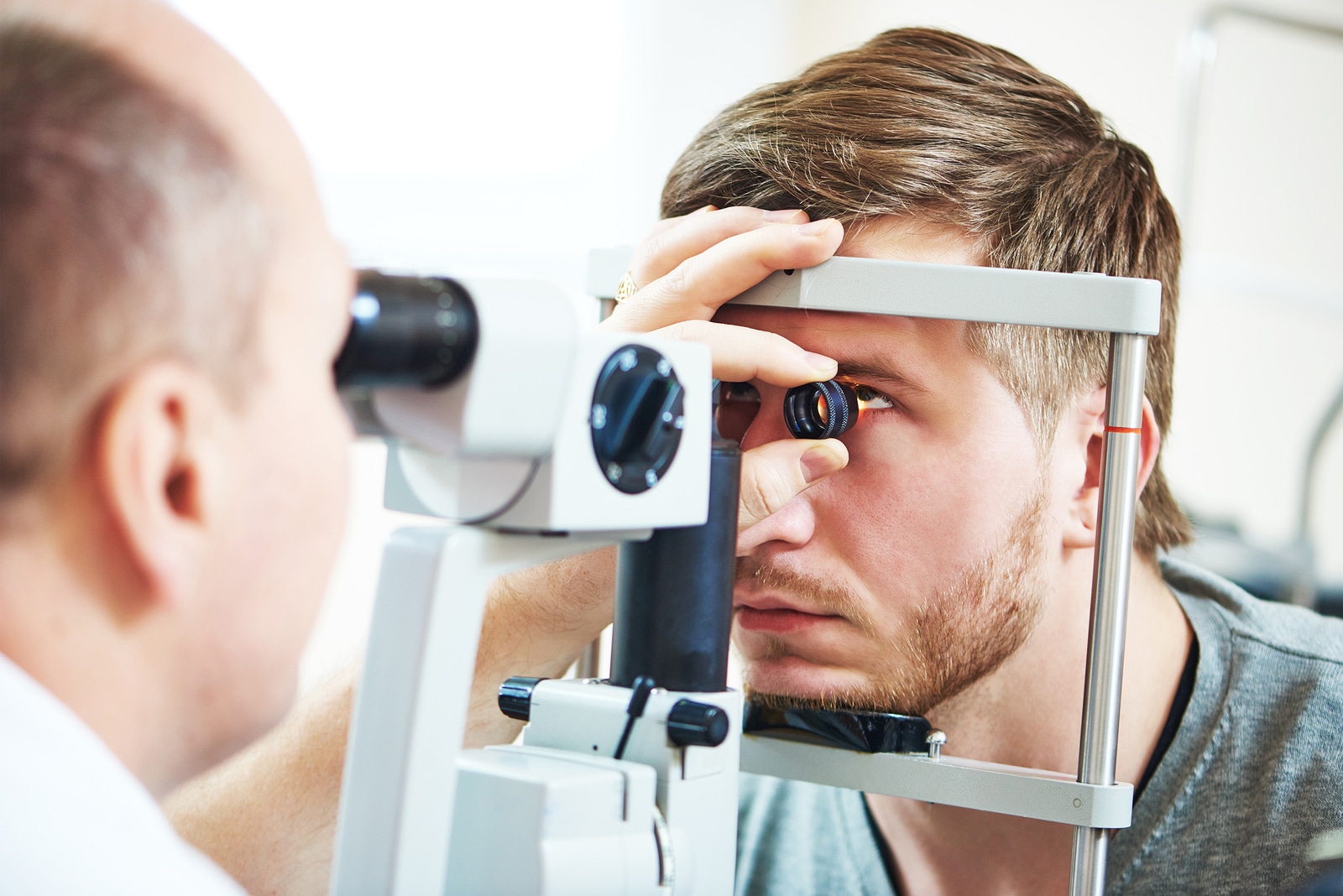 Ophthalmology concept. Male patient under eye vision examination in eyesight ophthalmological correction clinic