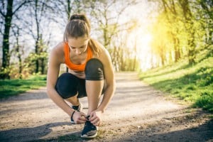 Young sportive woman getting ready to start running workout - Athlete running outdoors at sunset - Attractive girl making sport to lose weight and stay fit