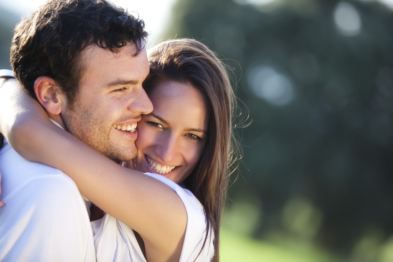 Closeup on young beautiful smiling couple.