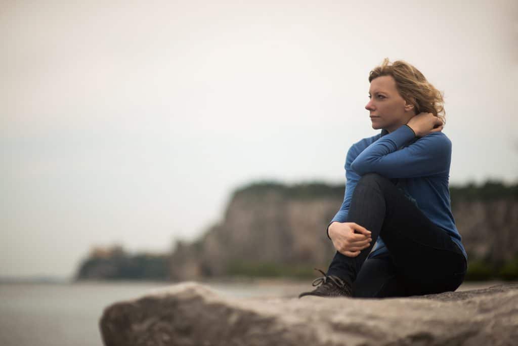 Pensive/dreaming woman on the beach