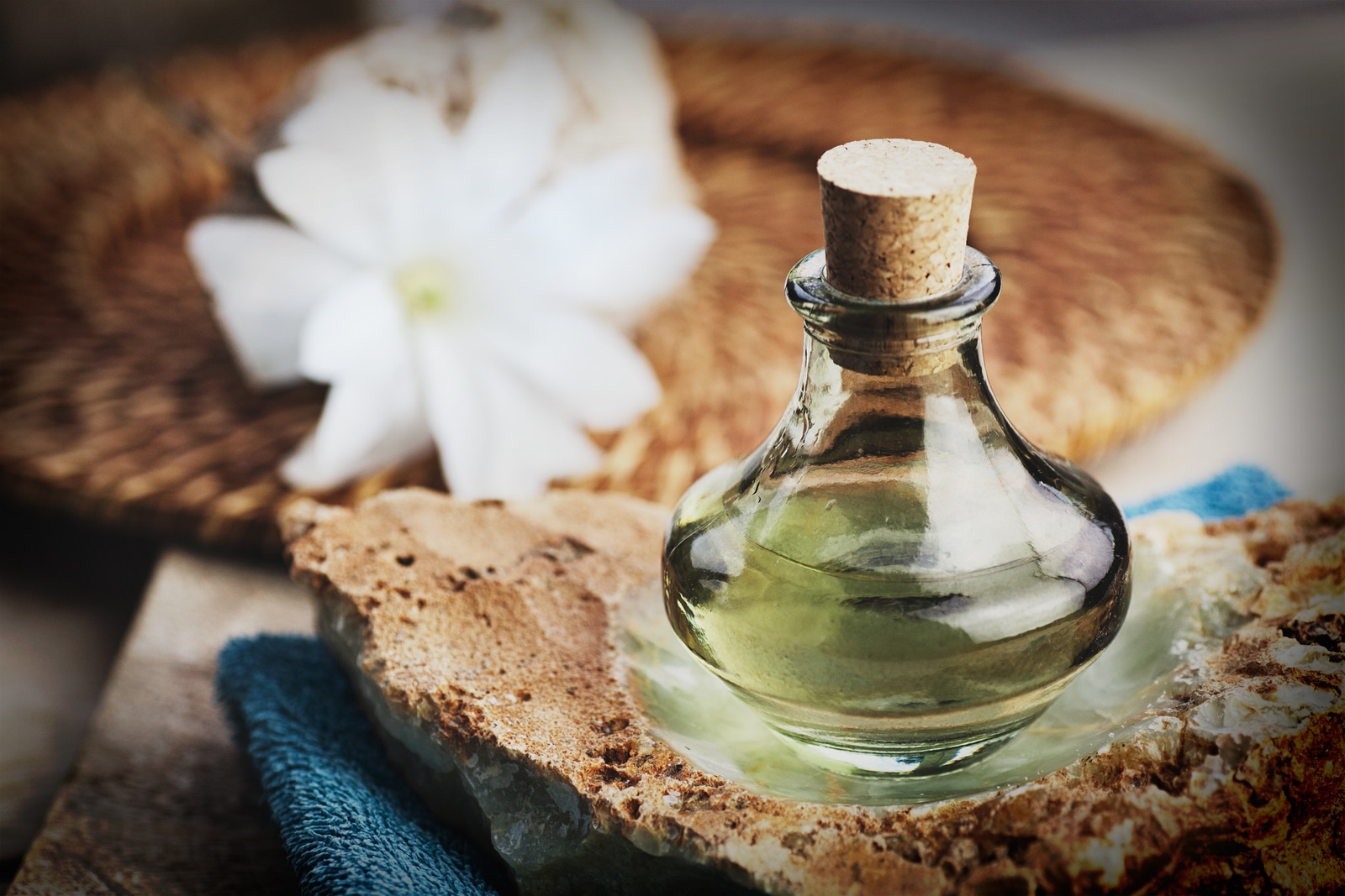 Spa and wellness setting with floral water towel and flower