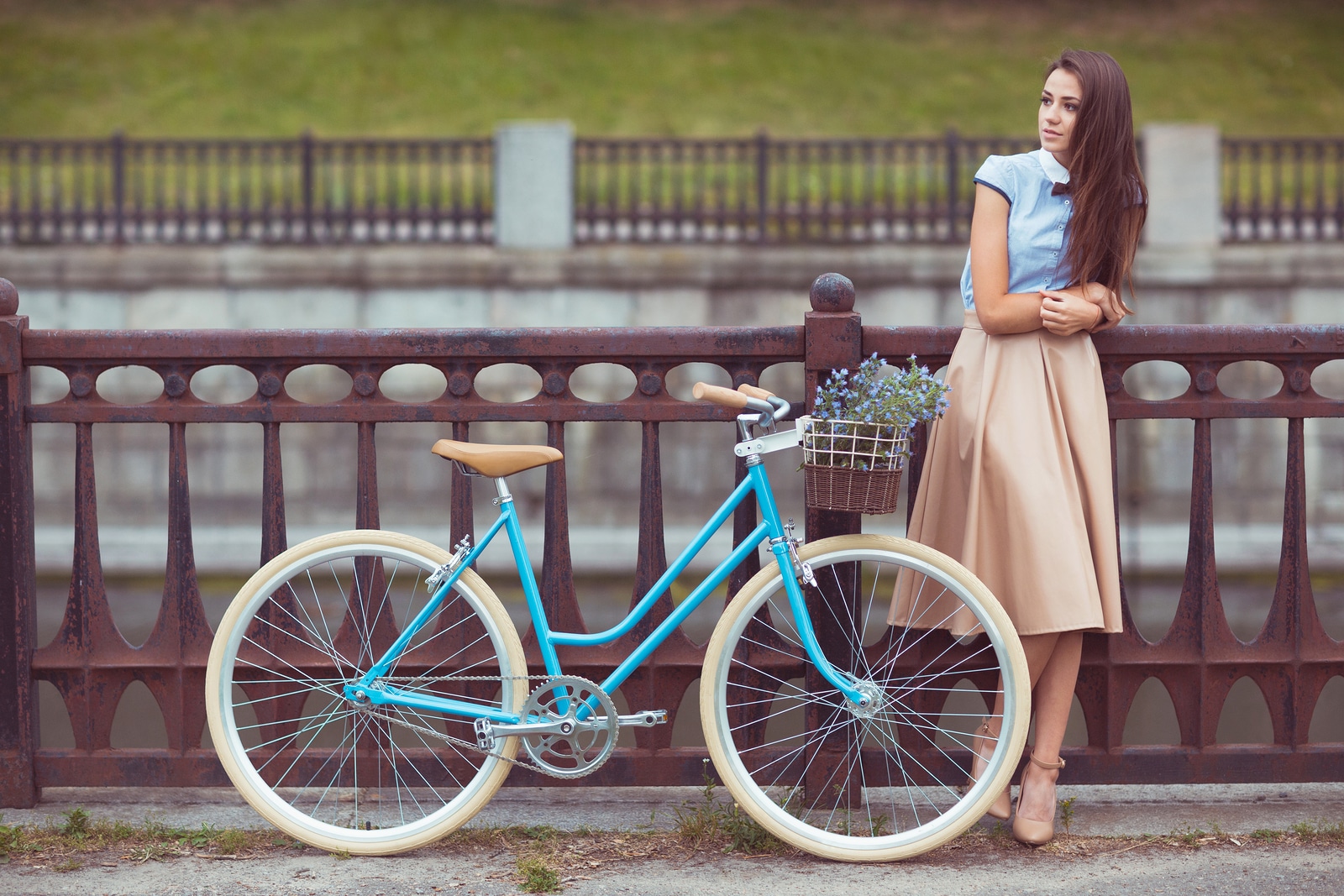 Young beautiful elegantly dressed woman with bicycle. Beauty fashion and lifestyle [[** Note: Shallow depth of field ** Note: Visible grain at 100%, best at smaller sizes