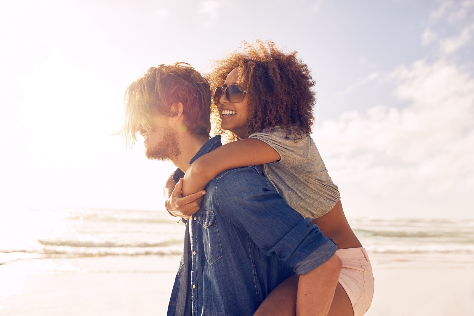 Young Couple Enjoying Their Summer Vacation On Beach