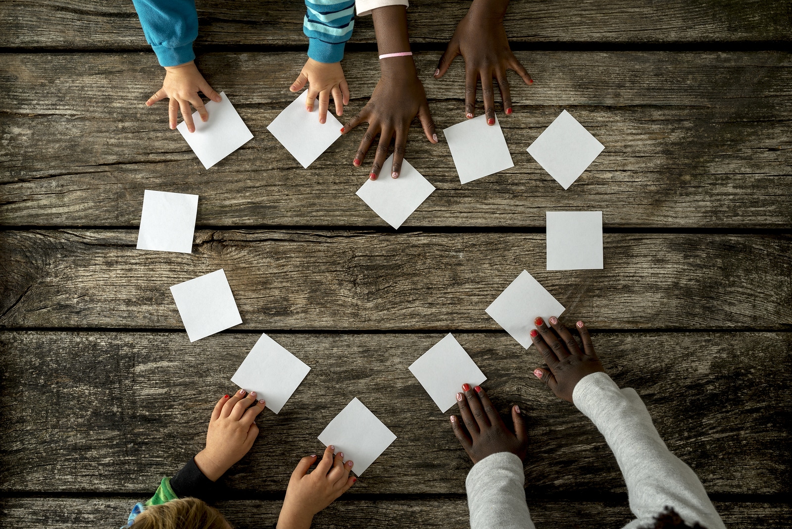 Four Children Of Mixed Races Assembling A Heart Shape Of White C