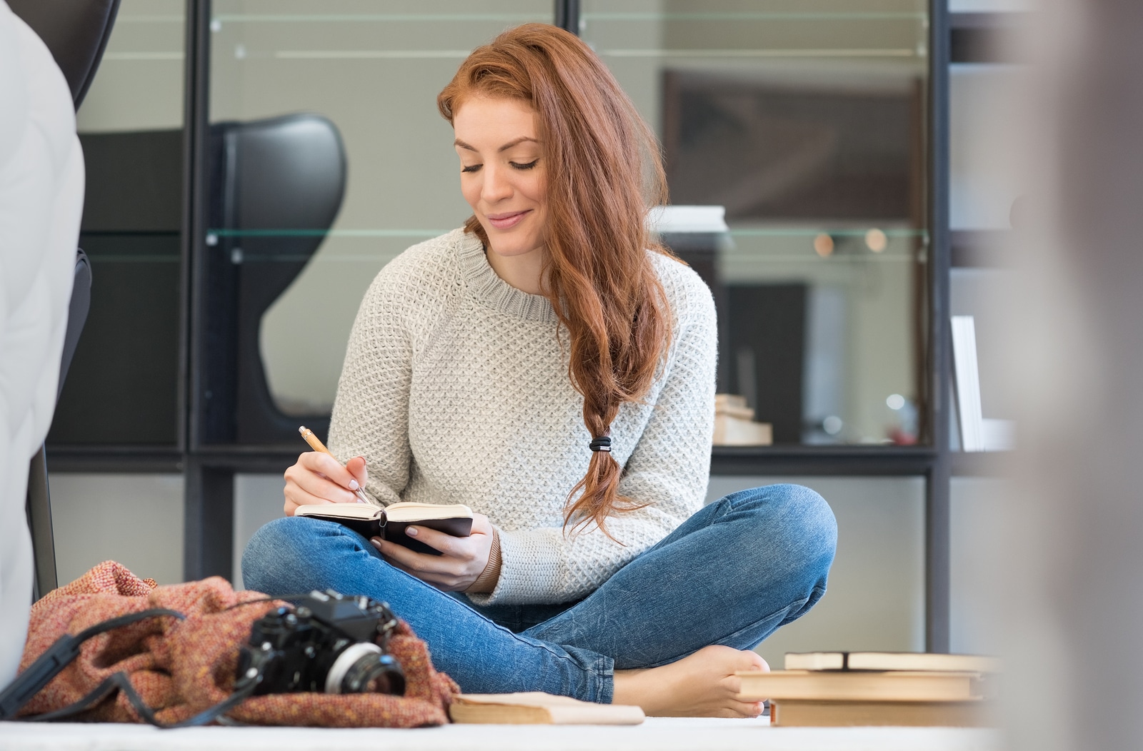 Happy young woman writing in diary. Young woman booking her date