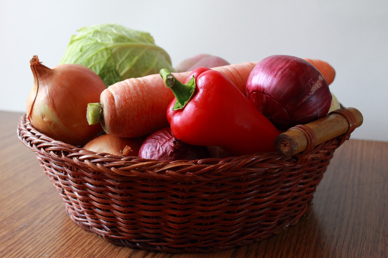 Fresh vegatables in a basket on the table.