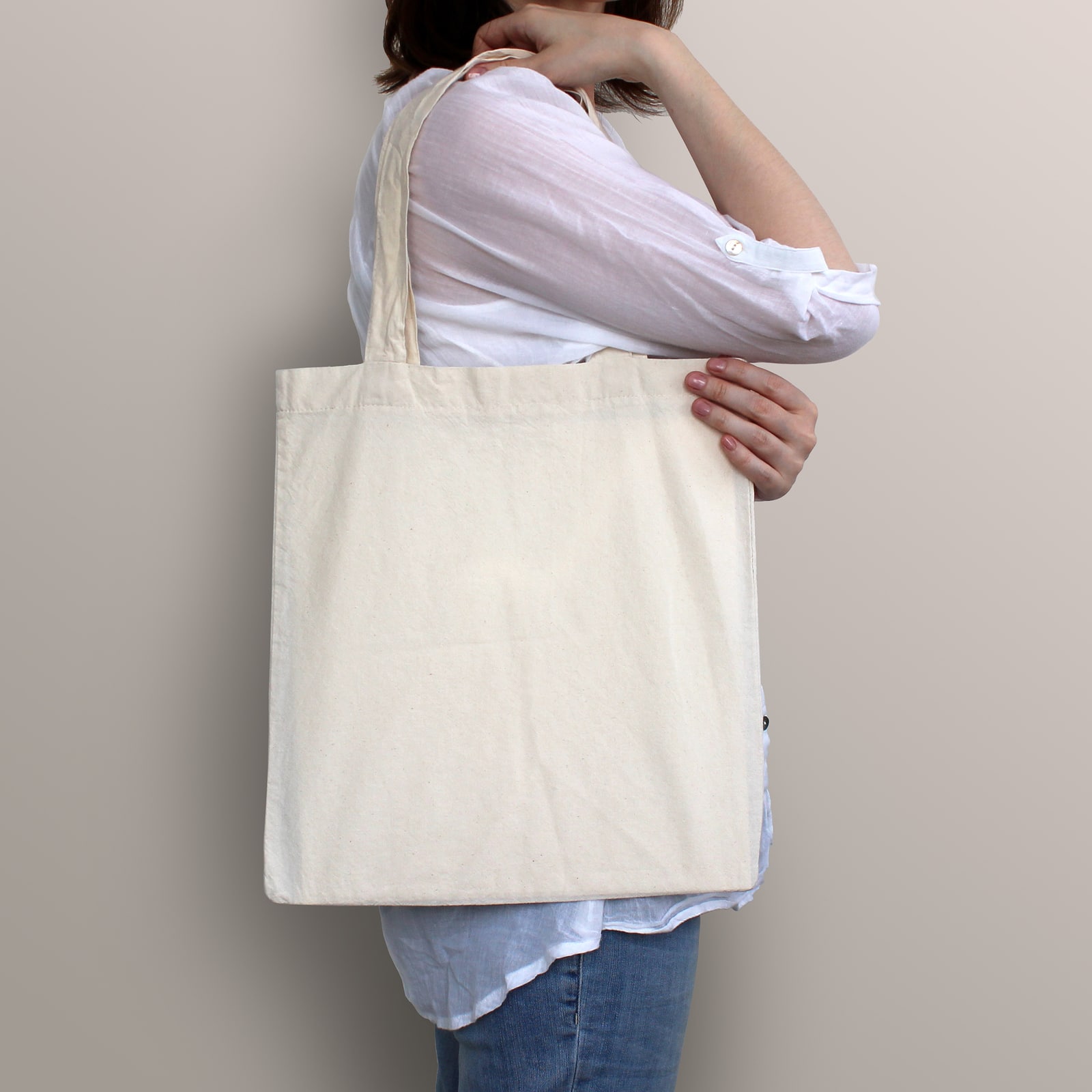 Girl is holding blank cotton eco bag design mockup. Handmade shopping bag for girls.