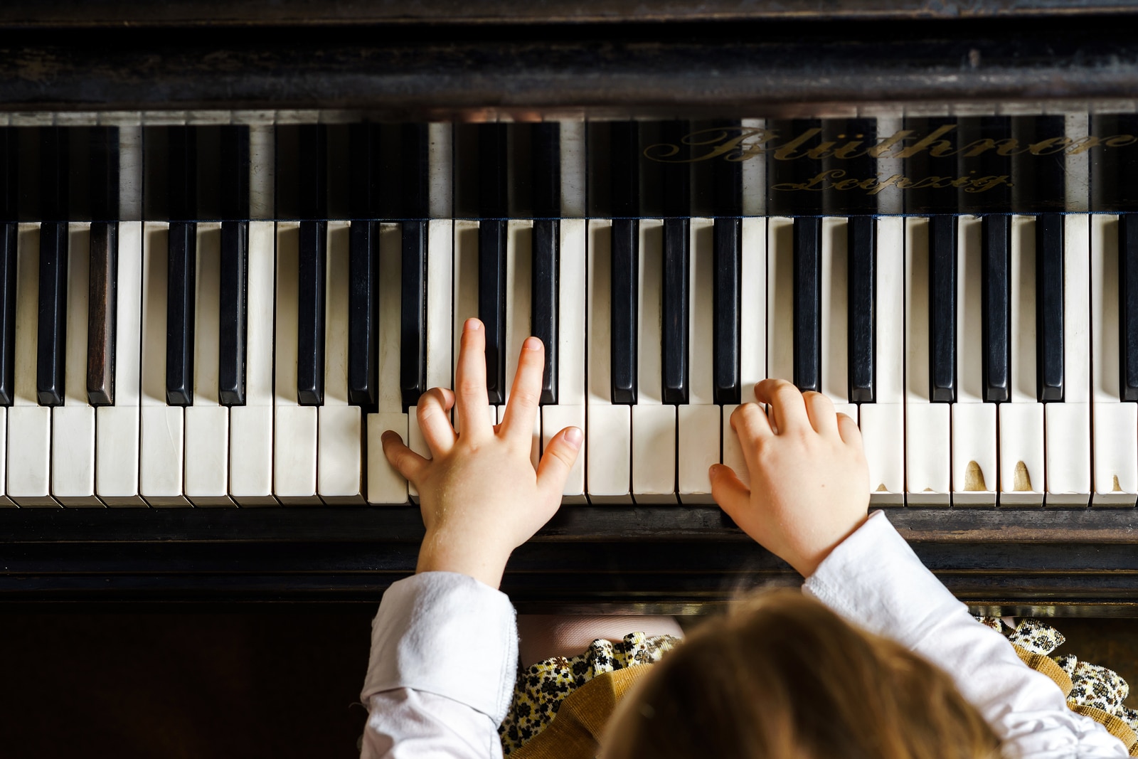 Cute Little Girl Playing Grand Piano In Music School