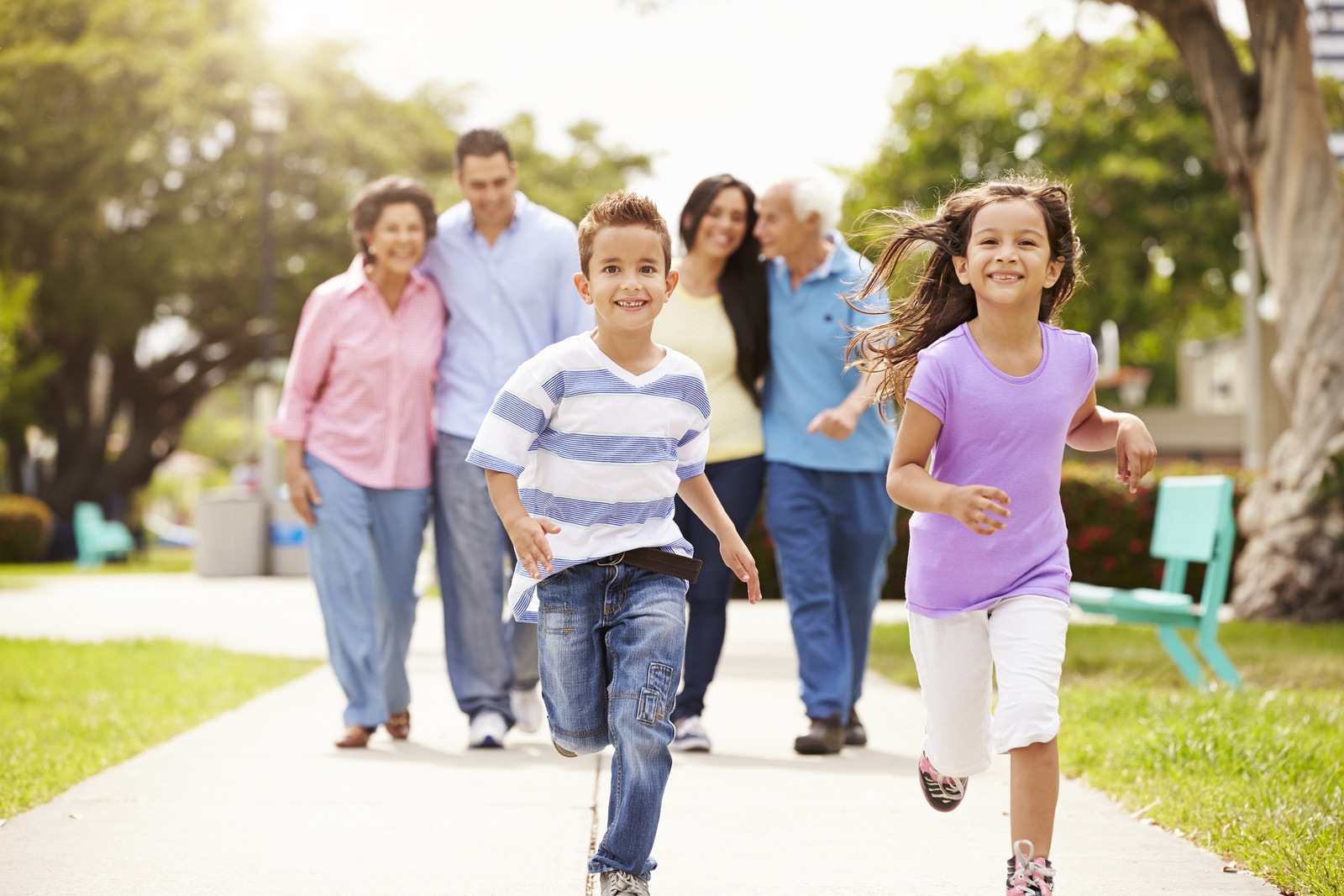 Multi Generation Family Walking In Park Together