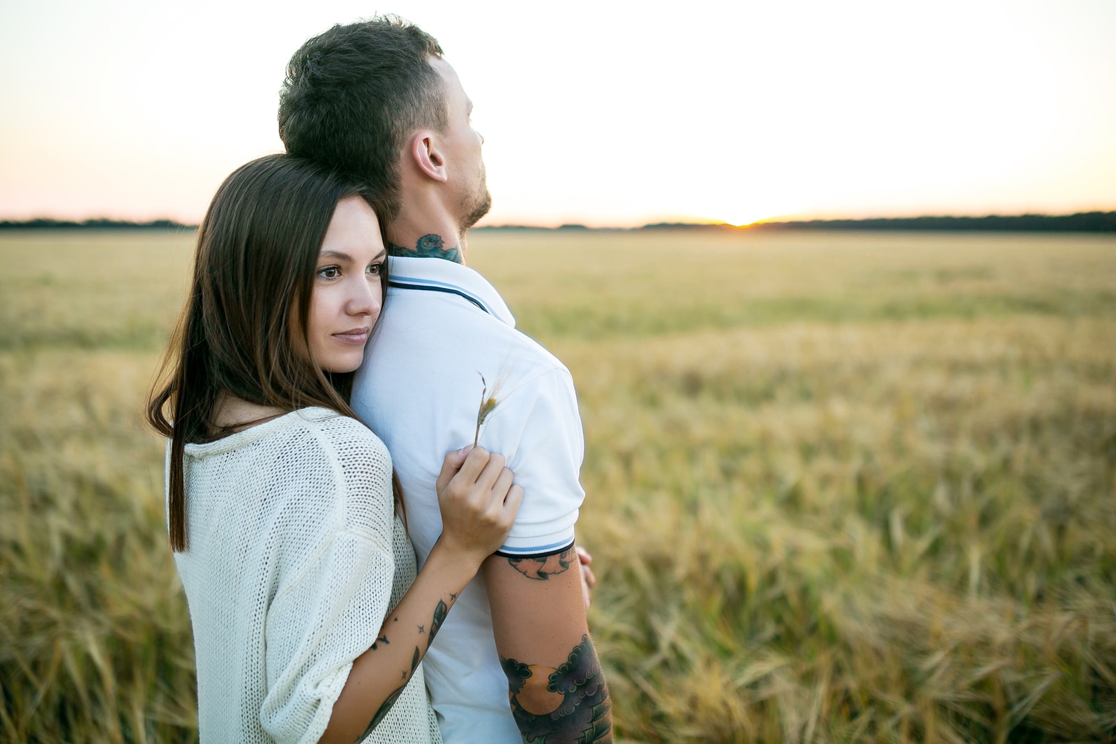 Couple in love - Beginning of a Love Story. A man and a girl with a tattoo on the nature