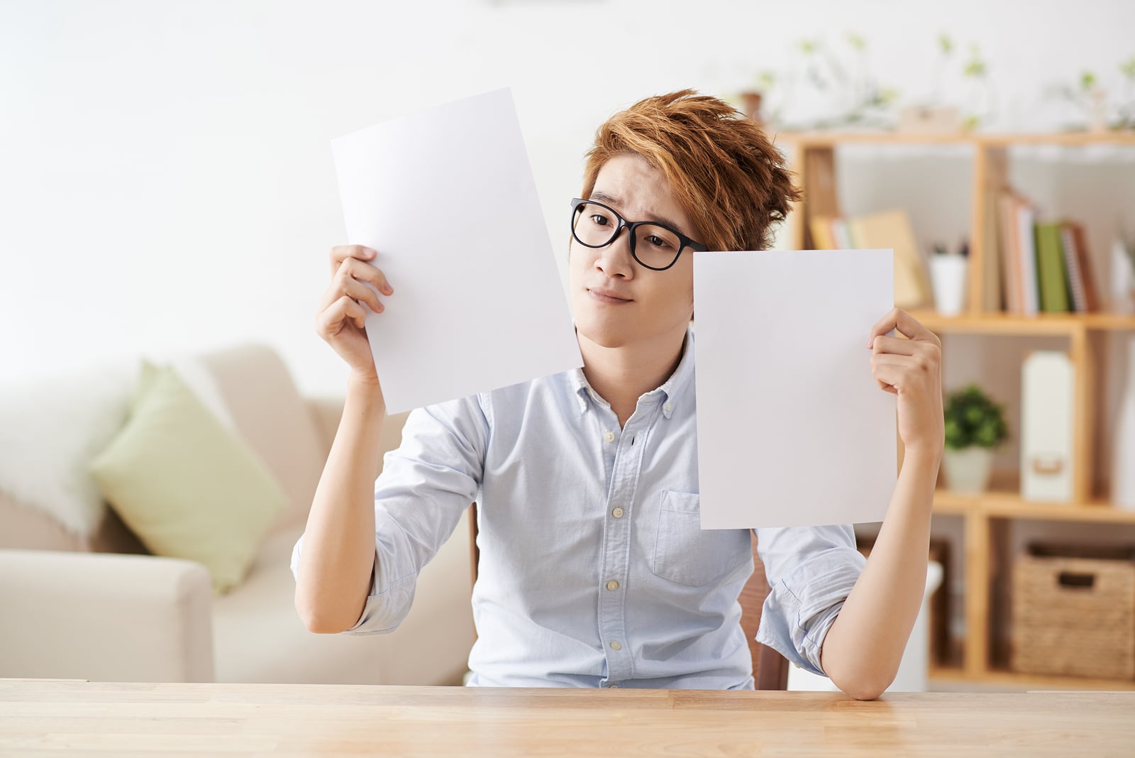 Portrait of Vietnamese man in doubt which sheet to choose