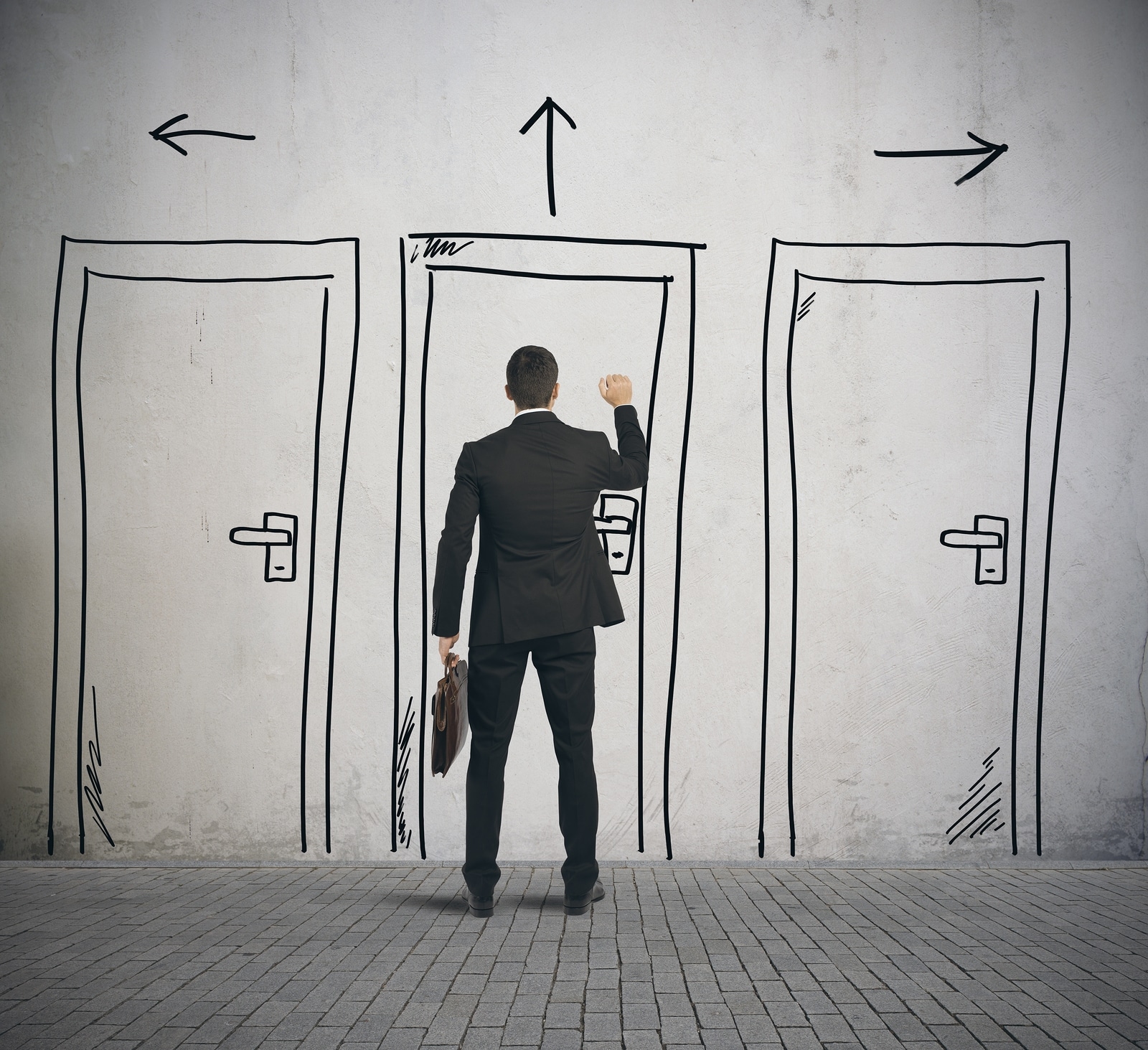 Businessman opens a door designed in a wall