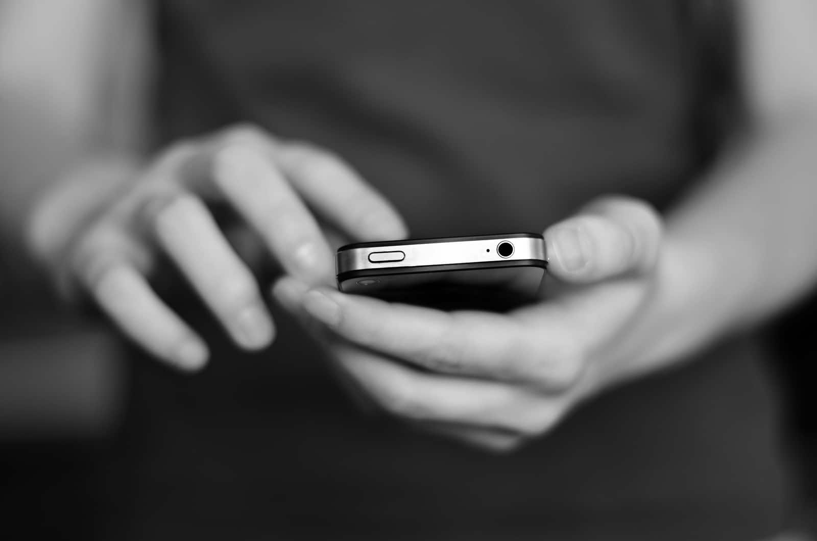 Person holding smart phone in hands to communicate and text