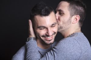 A gay couple on black background studio