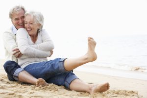 Senior Couple Sitting On Beach Together