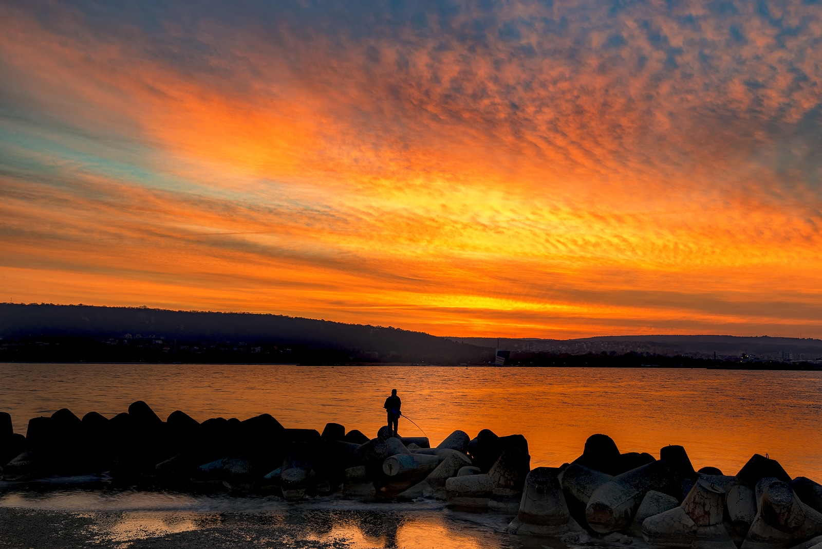 Fishing and fisherman at amazing sea sunset