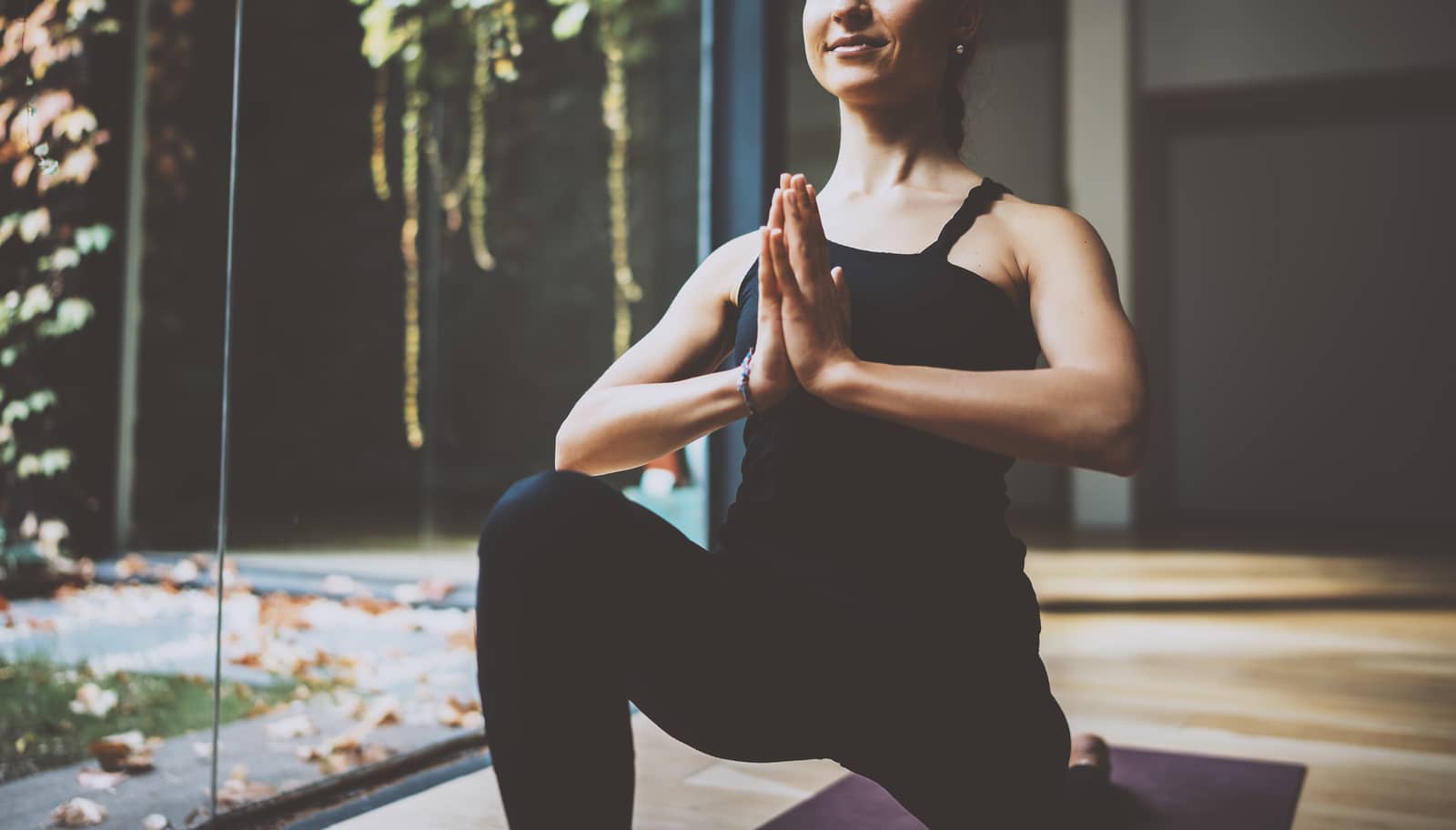 Close up view of gorgeous young woman practicing yoga indoor. Beautiful girl practice ardha matsyendrasana in class.Calmness and relax, female happiness concept.Horizontal, blurred background