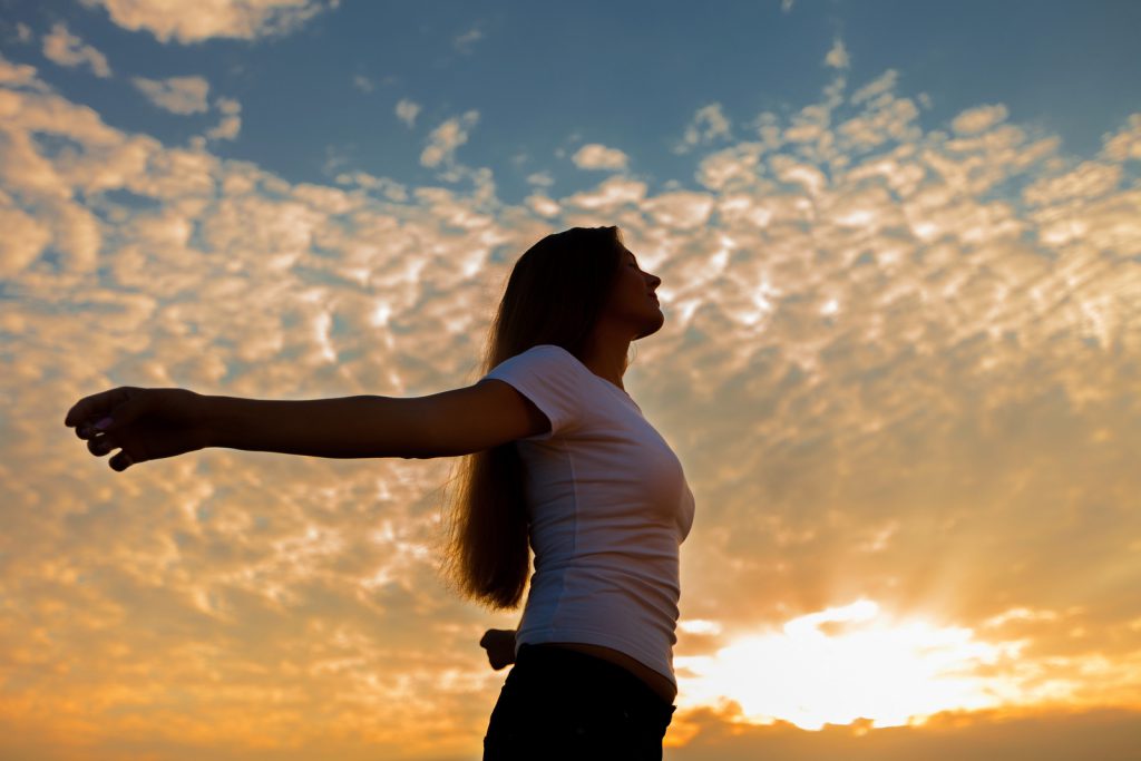 Praying / Meditating Woman at Dawn / Sunset