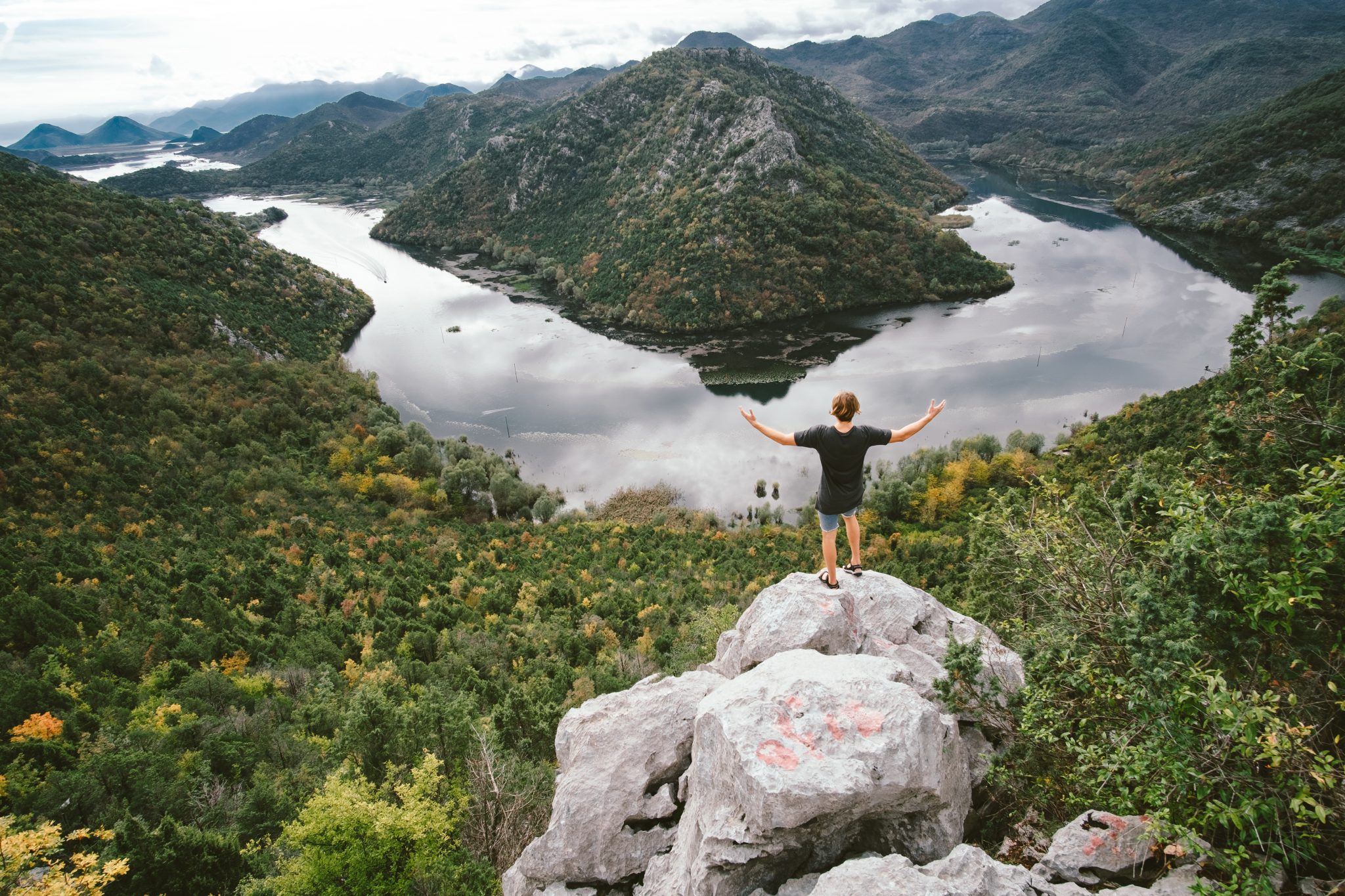 Man traveler sitting on the mountain and gaping freedom concept