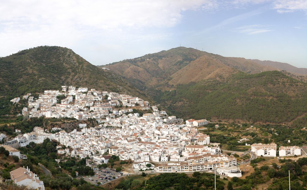 Aerial view of Ojen white village over a hillside near Marbella Spain. Panoramic