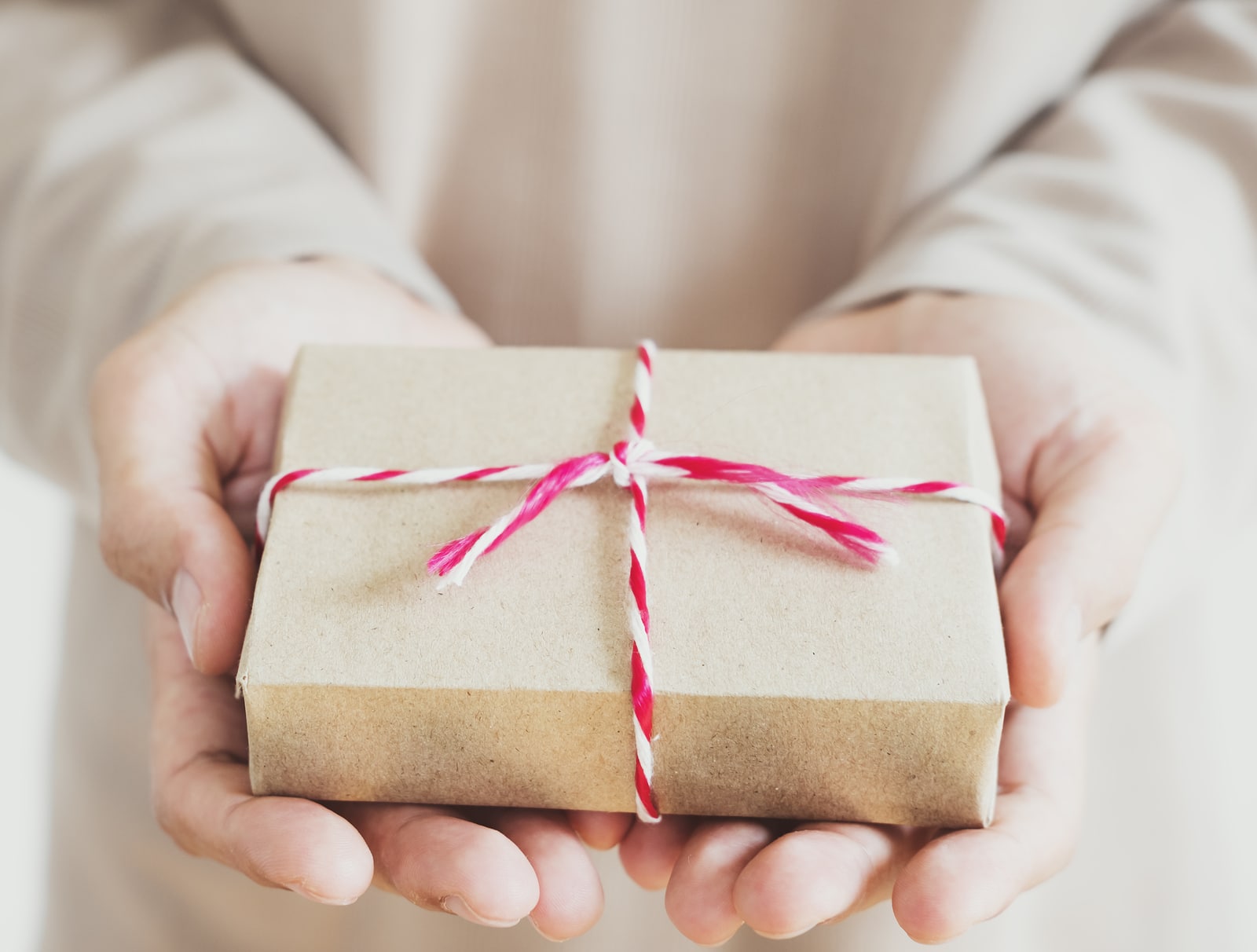 A man holding parcel post gift box on hand