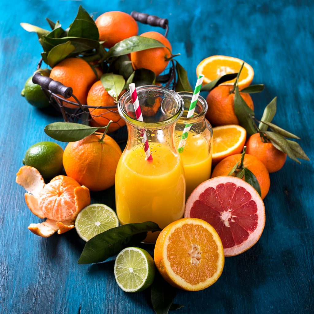 Citrus vitamin juice healthy drink with fresh fruits lime grapefruit orange tangerine. Refreshing homemade lemonade. Breakfast beverage. Square image