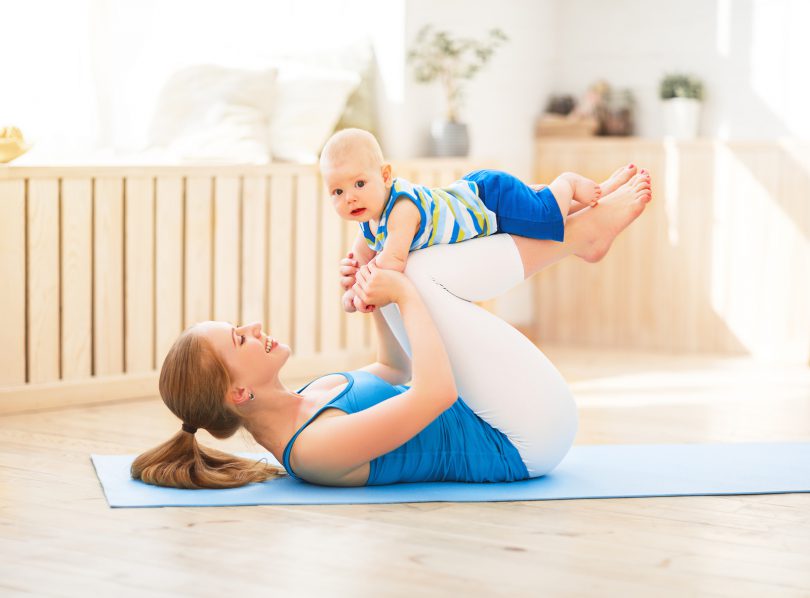 Mãe fazendo Yoga com seu bebe.