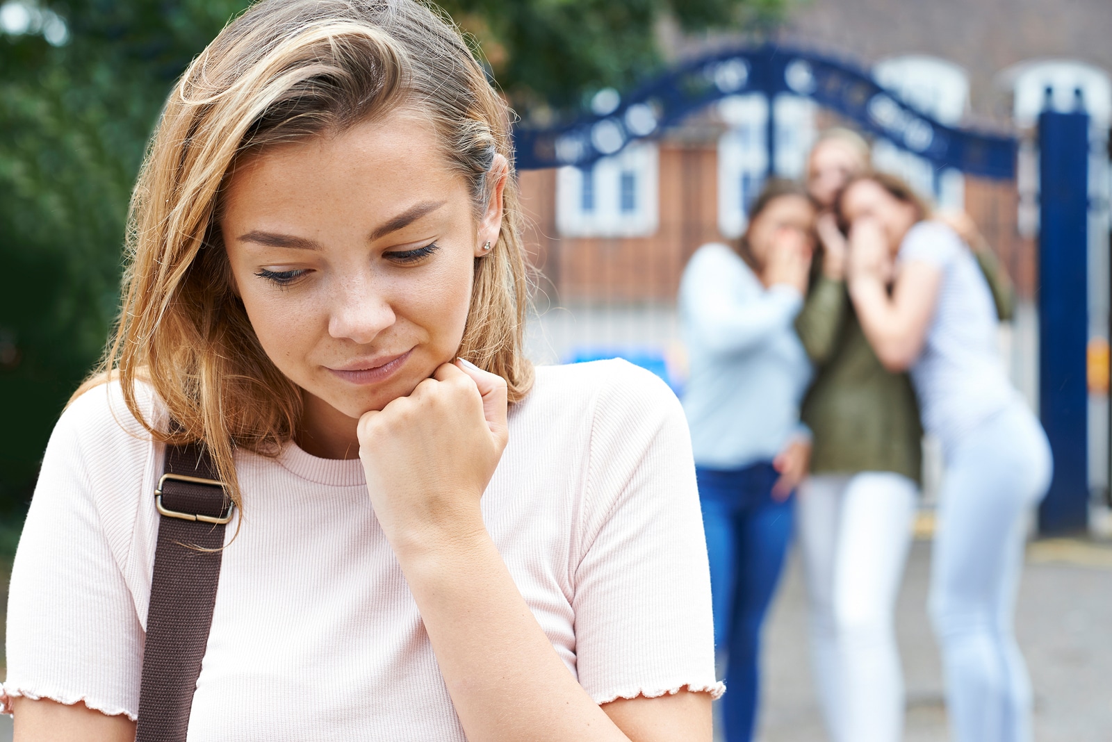 Unhappy Girl Being Gossiped About By School Friends