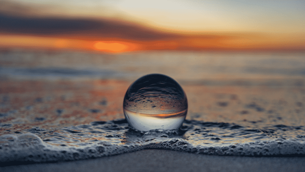 Globo transparente na praia durante o pôr-do-sol