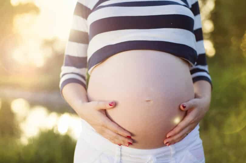 Barriga de grávida com mãos acariciando