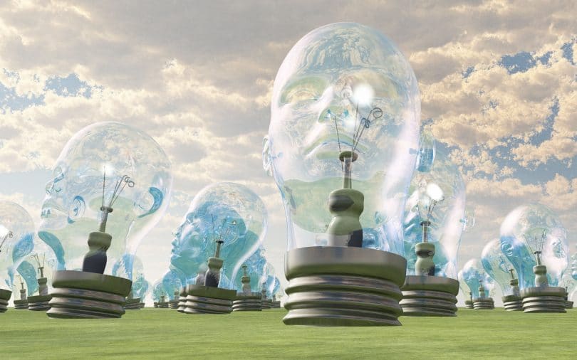 Ilustração de um grupo de lâmpadas gigantes cujo formato se assemelha a cabeças humanas, disposto em um campo.