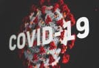 Vírus do coronavírus com letreiro grande escrito Covid-19.