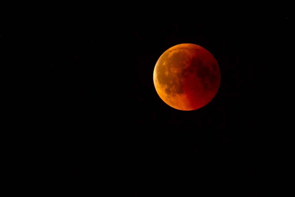 Imagem do eclipse lunar - a lua está alaranjada.