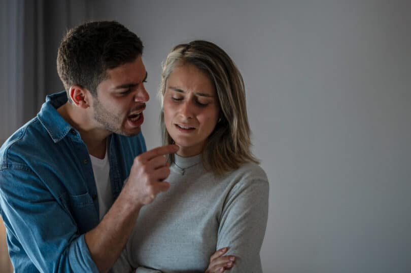 Homem discutindo com mulher enquanto aponta o dedo na cara dela