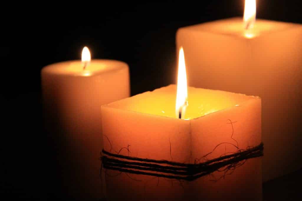 Imagem de três velas acesas representando a espiritualidade.