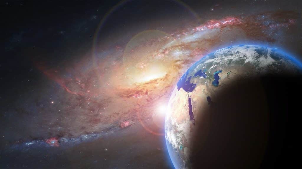 Imagem do universo com o planeta terra em destaque junto com o sol. Em volta, vários planetas.