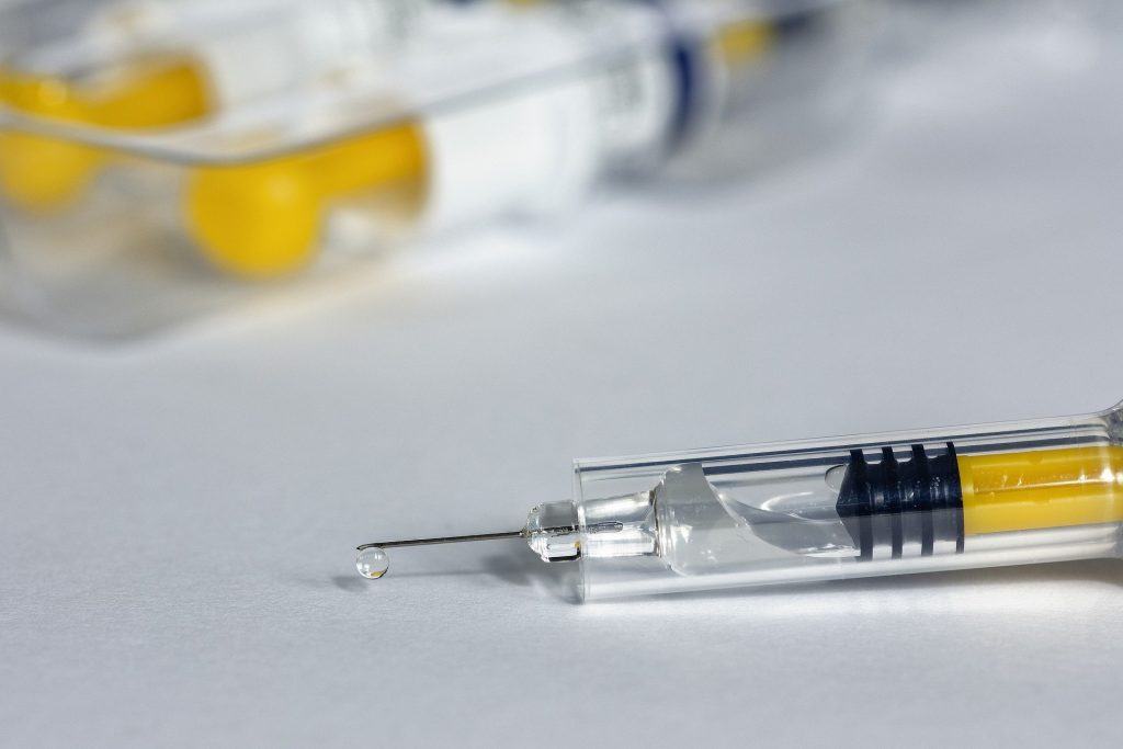 Imagem de uma injeção contraceptiva disposta sobre uma mesa branca.
