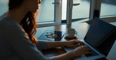 Mulher com as mãos no teclado do computador