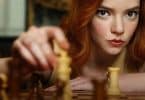 Mulher ruiva jogando xadrez.