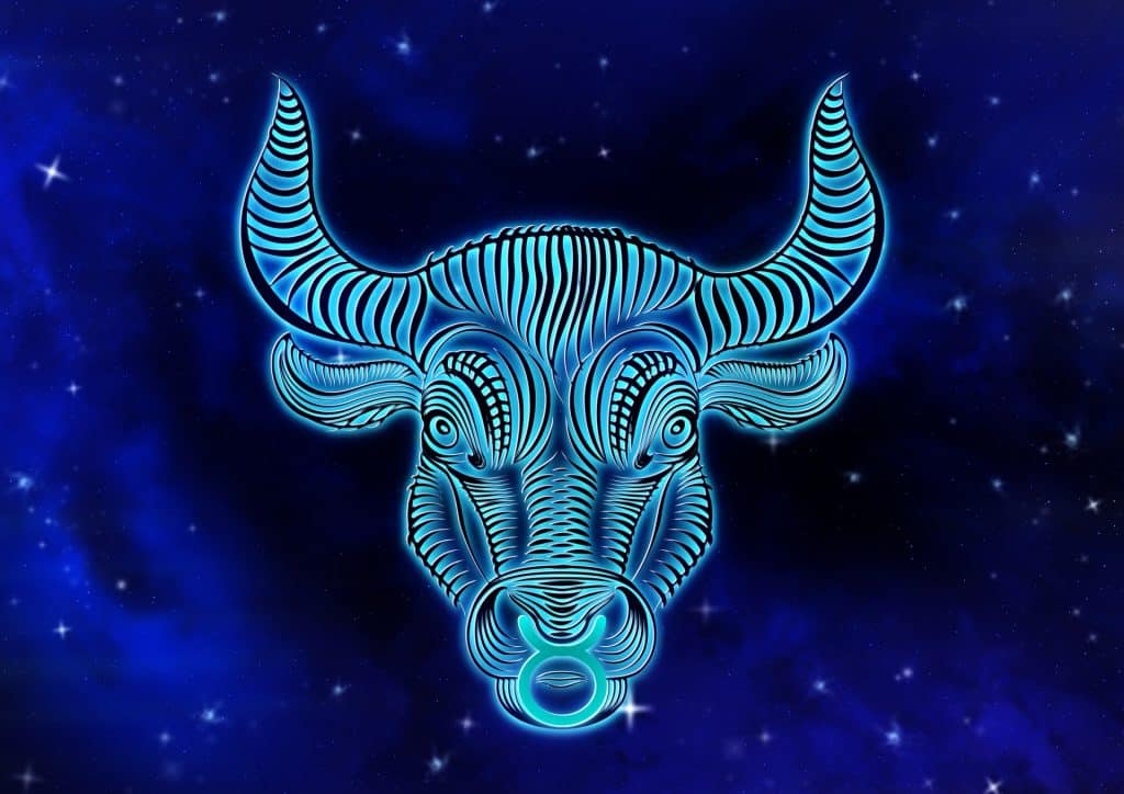Imagem de fundo azul trazendo o símbolo do signo de touro, sendo representado pela face do touro.