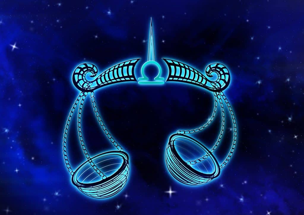 Imagem de fundo azul trazendo o símbolo do signo de libra, sendo representado por uma balança.