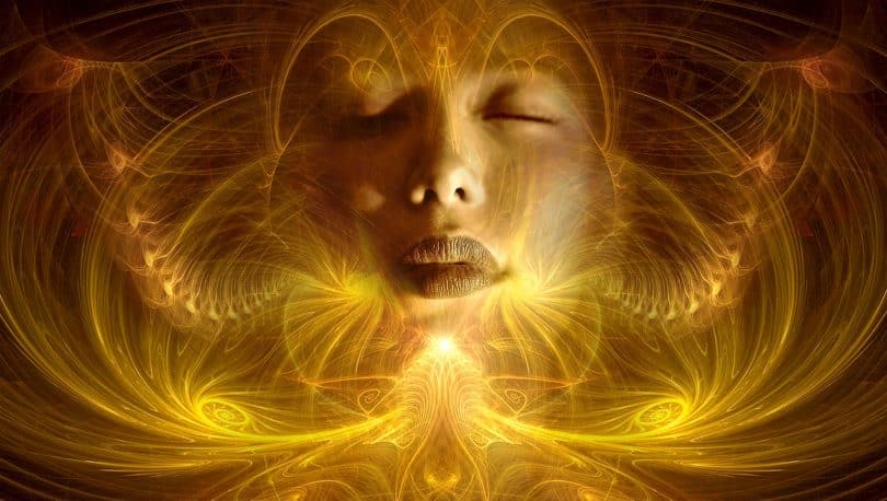 Imagem de muitas luzes na cor amarela e ao fundo o rosto de uma mulher, é uma imagem mágica, trazendo uma fantasia lúdica para representar as dimensões do mundo espiritual.